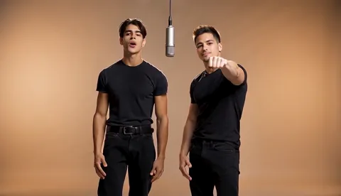 Preview of two performers moving and singing against an orange background